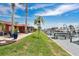 Lush backyard with a dock and palm trees overlooking the canal at 3850 Catalina Dr, Bradenton, FL 34210