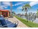 Scenic backyard featuring a boat dock, patio, and waterfront views at 3850 Catalina Dr, Bradenton, FL 34210