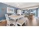 Charming dining room with a long table, blue accent wall, and bright chandelier at 3850 Catalina Dr, Bradenton, FL 34210