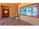 Hallway with a red door, bulletin board, and tiled floor at 3850 Catalina Dr, Bradenton, FL 34210