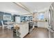 Bright, open kitchen with white cabinets and stainless steel appliances next to a dining area at 3850 Catalina Dr, Bradenton, FL 34210