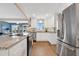 Modern kitchen with stainless steel appliances, white cabinetry, and granite countertops at 3850 Catalina Dr, Bradenton, FL 34210