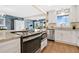 Bright kitchen with stainless appliances, granite counters, and a view to the living area at 3850 Catalina Dr, Bradenton, FL 34210