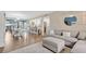 Open-concept living room with hardwood floors, modern decor, and abundant natural light at 3850 Catalina Dr, Bradenton, FL 34210