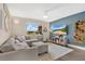 Bright living room featuring a large grey sofa, cool blue accents, and coastal decor at 3850 Catalina Dr, Bradenton, FL 34210