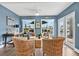 Cozy living room with wicker furniture and views of the water from multiple windows at 3850 Catalina Dr, Bradenton, FL 34210
