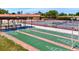 Exterior shuffleboard court with benches, tennis court, and an American flag at 3850 Catalina Dr, Bradenton, FL 34210