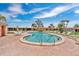 Outdoor swimming pool surrounded by lounge chairs, tables, and tropical landscaping at 3850 Catalina Dr, Bradenton, FL 34210