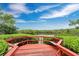 Waterfront nature preserve featuring red painted railing and observation deck surrounded by lush greenery at 3850 Catalina Dr, Bradenton, FL 34210