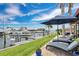 Peaceful waterfront view featuring lawn chairs, landscaping, boat lift, and waterfront views against a blue sky at 3850 Catalina Dr, Bradenton, FL 34210