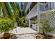 Charming backyard area with tropical plants and outdoor space at 401 N Bay Blvd, Anna Maria, FL 34216