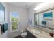Bathroom featuring a granite countertop, a window, and decorative touches at 401 N Bay Blvd, Anna Maria, FL 34216