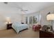 Bright bedroom with ceiling fan, shuttered windows, and comfortable furnishings at 401 N Bay Blvd, Anna Maria, FL 34216