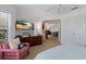 Bedroom showcasing large windows with sun shutters, a comfortable chair, and a television at 401 N Bay Blvd, Anna Maria, FL 34216