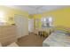 Bedroom boasting bright yellow walls, wicker furniture, and ample closet space at 401 N Bay Blvd, Anna Maria, FL 34216