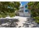 Two-story home featuring a large driveway and a two-car garage at 401 N Bay Blvd, Anna Maria, FL 34216