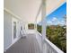 Charming outdoor porch with ample seating and views of the surrounding tropical landscape at 401 N Bay Blvd, Anna Maria, FL 34216