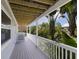 Inviting outdoor porch with tropical landscaping at 401 N Bay Blvd, Anna Maria, FL 34216