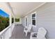 Inviting outdoor porch with comfortable seating and lush greenery views at 401 N Bay Blvd, Anna Maria, FL 34216