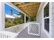 Relaxing outdoor porch with wood ceiling and tropical greenery views at 401 N Bay Blvd, Anna Maria, FL 34216