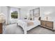 Comfortable bedroom with a cozy bed, neutral decor, and ample natural light from a window at 4104 Gold Dust Ln, Sarasota, FL 34243