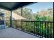 This screened balcony overlooks greenery and trees, with black metal railings at 4532 Chinkapin Dr, Sarasota, FL 34232