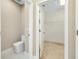 Clean bathroom featuring a toilet and an open door to a closet, showcasing storage solutions at 4532 Chinkapin Dr, Sarasota, FL 34232