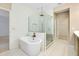 An elegant bathroom features a soaking tub, glass shower, and neutral tile at 4532 Chinkapin Dr, Sarasota, FL 34232