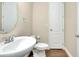 Powder room features pedestal sink, modern toilet, and wood-look flooring at 4532 Chinkapin Dr, Sarasota, FL 34232