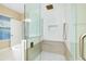 Modern bathroom with a frameless glass shower, a built-in bench, and mosaic tile flooring at 4532 Chinkapin Dr, Sarasota, FL 34232