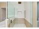 Walk-in shower featuring sleek glass walls, a rainfall showerhead, and a comfortable built-in bench at 4532 Chinkapin Dr, Sarasota, FL 34232