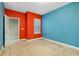 Bright bedroom featuring carpeted floors, a large window, and colorful walls at 4532 Chinkapin Dr, Sarasota, FL 34232