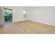 Bright room with carpet and entrance to balcony with lots of light at 4532 Chinkapin Dr, Sarasota, FL 34232