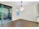 Bright dining room with sliding door, modern light fixture, and tile flooring at 4532 Chinkapin Dr, Sarasota, FL 34232