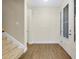 Bright home entryway with wood-look flooring leading to a carpeted staircase at 4532 Chinkapin Dr, Sarasota, FL 34232