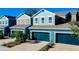 Charming townhomes featuring blue exteriors, private garages, and well-maintained landscaping at 4532 Chinkapin Dr, Sarasota, FL 34232