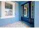 Blue exterior featuring a charming front door with sidelights and a window at 4532 Chinkapin Dr, Sarasota, FL 34232