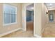 Hallway with a bedroom in view through an open door, a large window, and carpet flooring at 4532 Chinkapin Dr, Sarasota, FL 34232