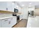 Bright kitchen features white cabinets, stainless steel appliances, quartz counters, and modern backsplash at 4532 Chinkapin Dr, Sarasota, FL 34232