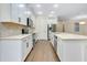 Modern kitchen featuring an island with breakfast bar and stainless steel appliances at 4532 Chinkapin Dr, Sarasota, FL 34232