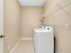 Well-lit laundry room with washer, dryer, and shelving; convenient home feature at 4532 Chinkapin Dr, Sarasota, FL 34232