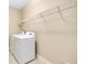 Practical laundry area equipped with a washer, dryer, and storage shelving at 4532 Chinkapin Dr, Sarasota, FL 34232