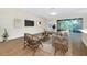Living room with neutral paint, wood-look tile floors, and sliding glass doors to a patio at 4532 Chinkapin Dr, Sarasota, FL 34232