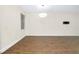 Living room featuring wood-look flooring, a window, and neutral paint color at 4532 Chinkapin Dr, Sarasota, FL 34232