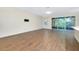 Open living room with wood-look tile floors and sliding doors to the patio area at 4532 Chinkapin Dr, Sarasota, FL 34232