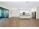 Bright open space with wood-look tile flooring and modern kitchen featuring stainless steel appliances at 4532 Chinkapin Dr, Sarasota, FL 34232