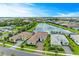 Beautiful waterfront homes with tile roofs and lush landscaping overlooking a serene lake at 4915 Kiva Cir, Bradenton, FL 34211