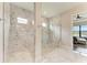 Luxurious bathroom featuring a spacious walk-in shower with marble walls and a glass enclosure at 4915 Kiva Cir, Bradenton, FL 34211