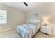 Cozy bedroom with patterned bedding, a side table, and a large window with ample natural light at 4915 Kiva Cir, Bradenton, FL 34211
