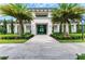 Grand clubhouse entrance with lush tropical landscaping and stone walkway at 4915 Kiva Cir, Bradenton, FL 34211